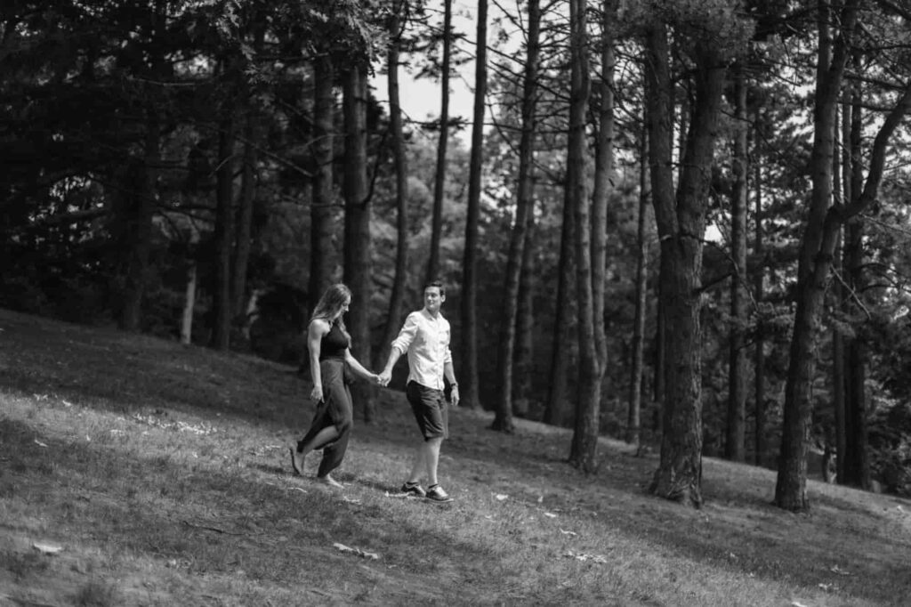 Couple walking down hill holding hands