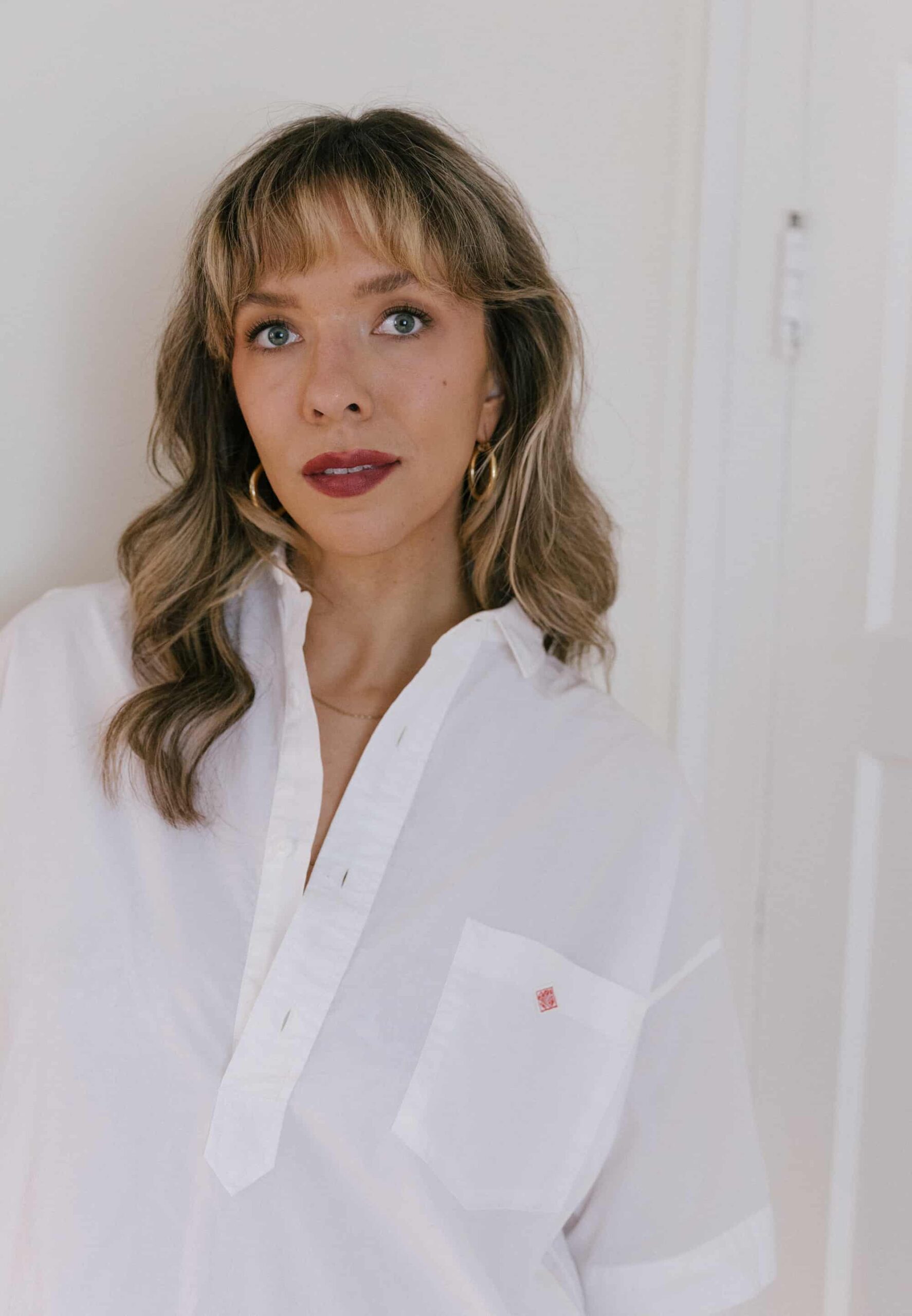 simple headshot of young woman against a white backdrop
