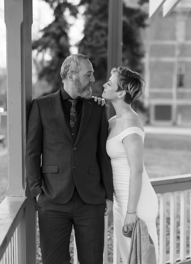 groom looking at bride while bride rests hand on groom's shoulder