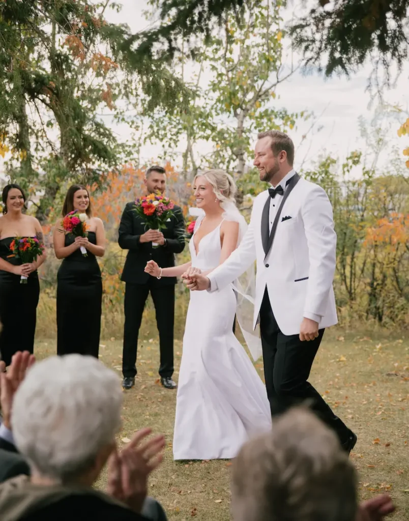 wedding with the bride and groom walking away together after getting married
