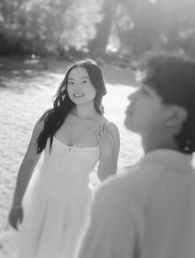 Woman smiling at her fiancé during a Wihkwentowin engagement session in Edmonton